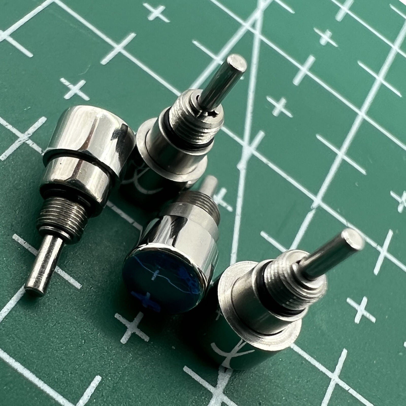 Wholesale Watch stainless steel silver classical pusher showcasing drive-in mechanism for durable timekeeping.