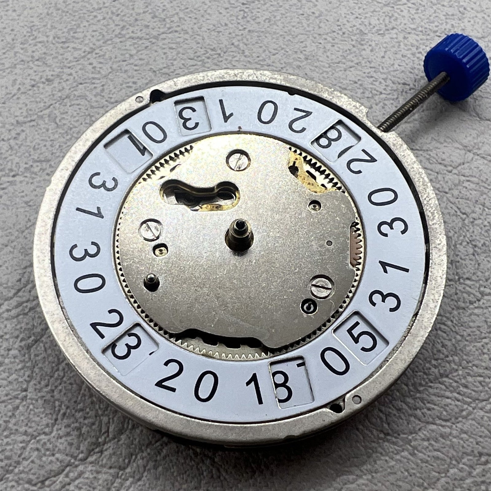 Swiss Ronda 5050B quartz watch movement with date at 6 o'clock and three hands for precise timekeeping.