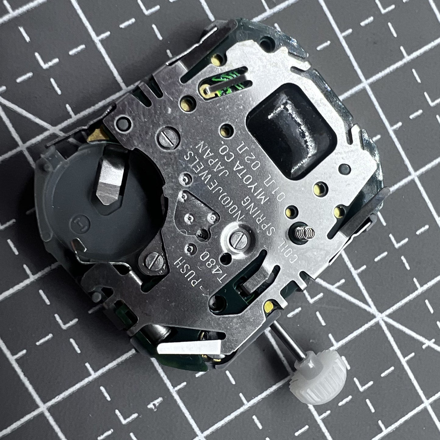 Japan Miyota T480 quartz movement watch mechanism with 3 hands and display screen for precise timekeeping.