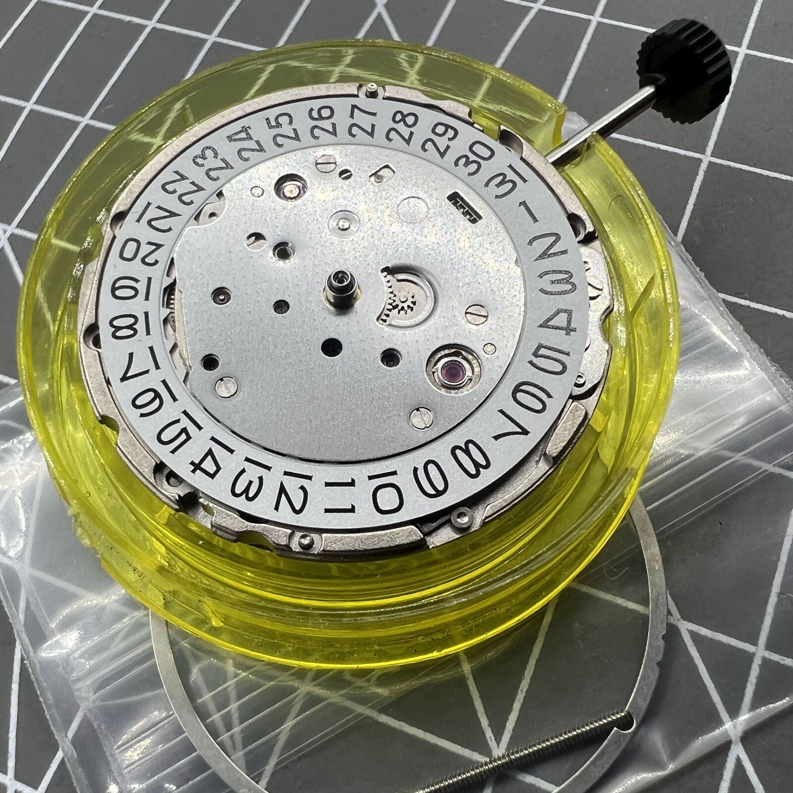 Miyota/Citizen 9019 automatic mechanical watch movement showing date window at 3 and 6, Japan made.