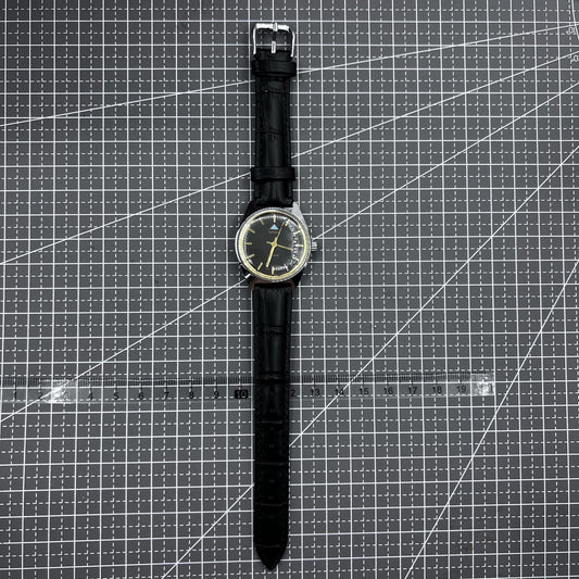 Taihang 32mm manual mechanical watch with black strap, golden nails, and black dial for classic style.