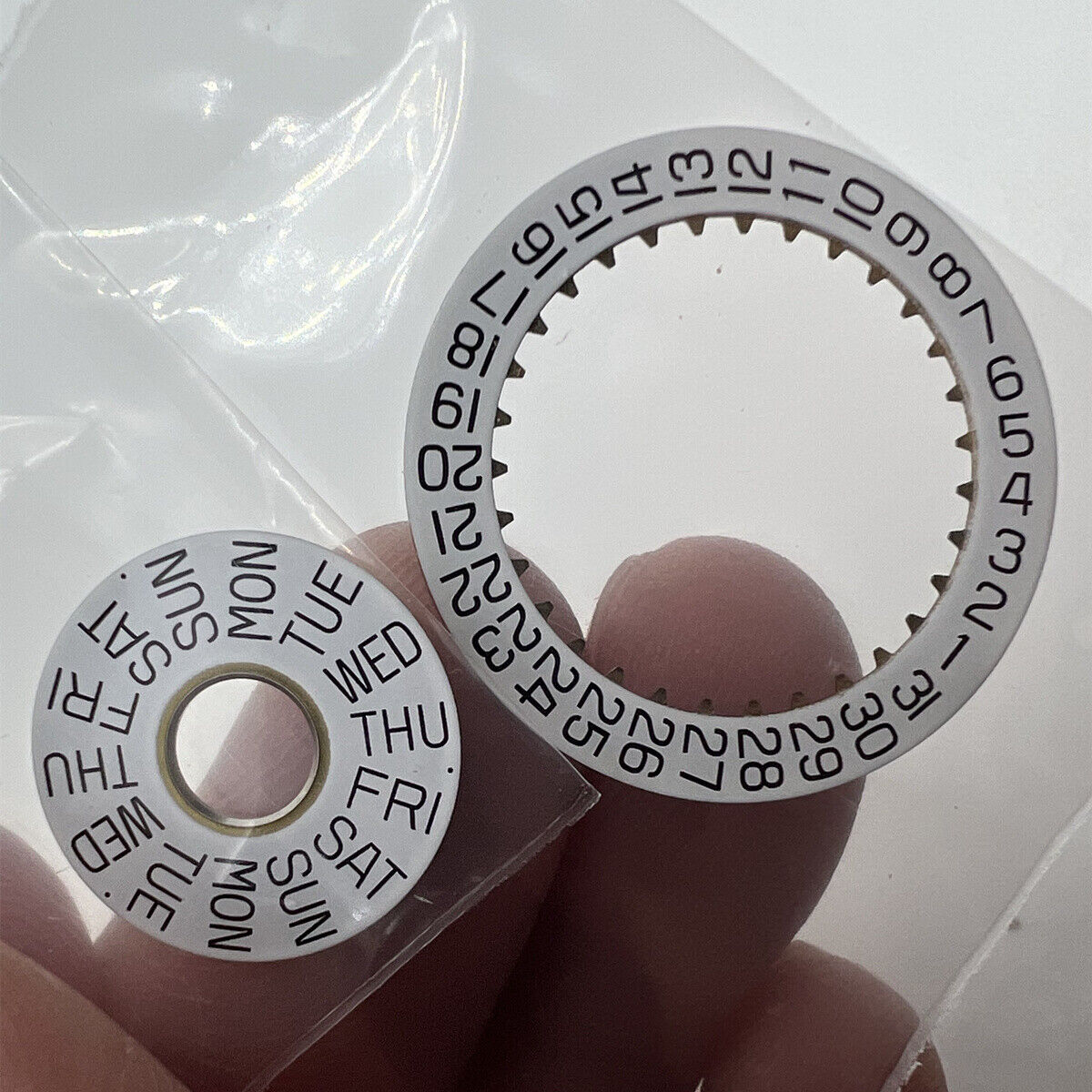 White date disk wheel showing date numbers, genuine ETA7750 movement part for watch repair.