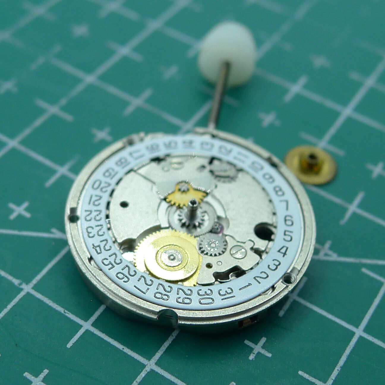 Wholesale ETA 956.114 quartz watch movement with white dial and 3-hand display, ideal for repair and replacement.