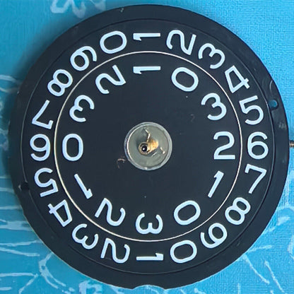 Swiss Made Ronda 519 quartz watch movement with black disk for precise timekeeping in watch repairs.