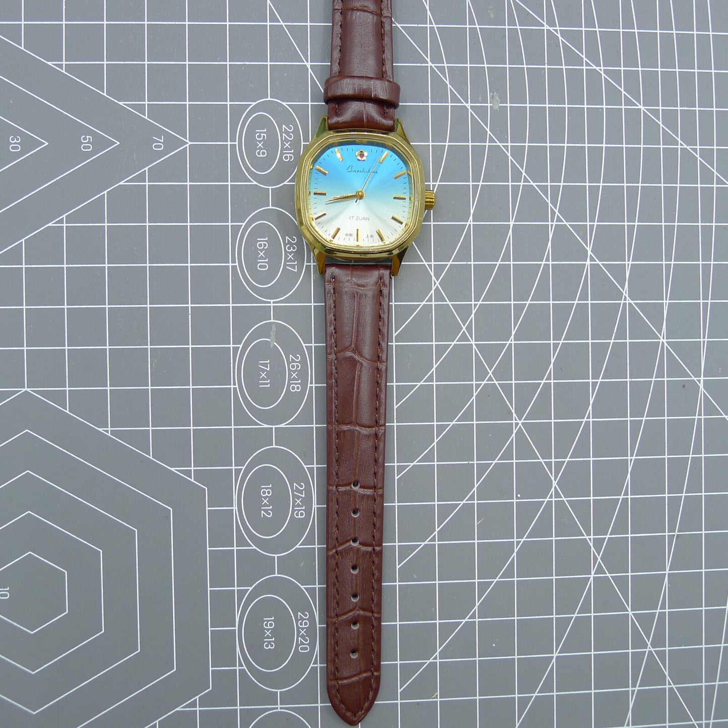 Shanghai 33mm watch with blue dial, gold nail markers, square case, manual mechanical movement, 17 jewels.
