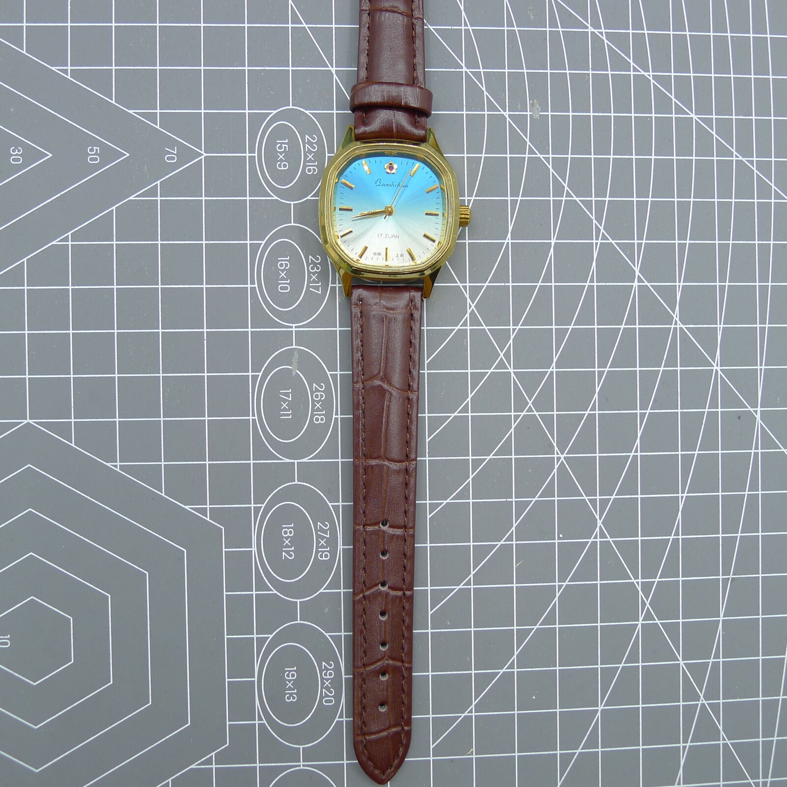 Shanghai 33mm watch with blue dial, gold nail markers, square case, manual mechanical movement, 17 jewels.