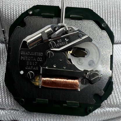 Japan Miyota 2317 quartz watch movement with date display at 3 o'clock, silver repair part for precision timekeeping.