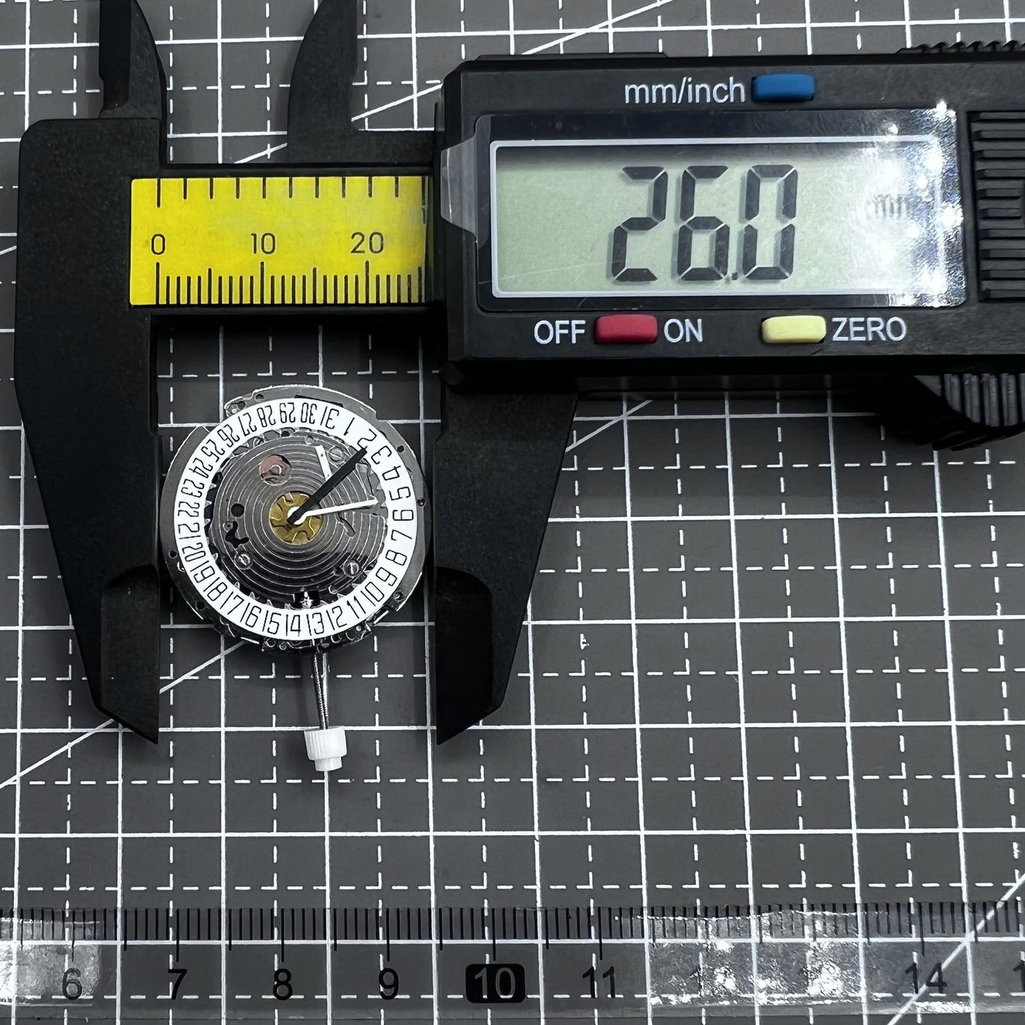 Swiss ISA 8171A quartz watch movement with white dial, four hands, and date at 6 o?clock for precise timekeeping.