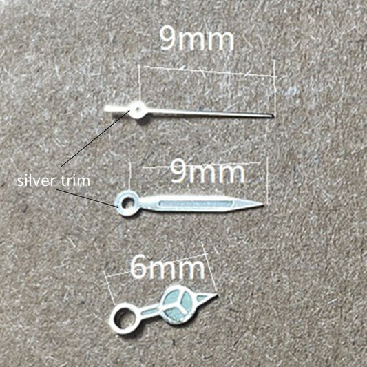 Silver trimmed green luminous watch hands for Miyota 1M12 movement, enhancing night-time readability.