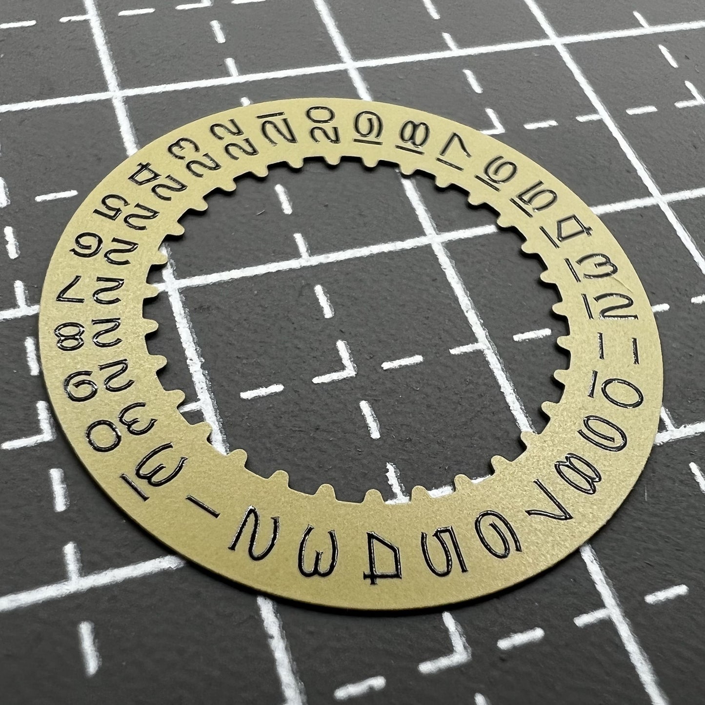 Vintage gold-tone date disc with numerals for RLX3135 watch movement, perfect for classic timepieces.