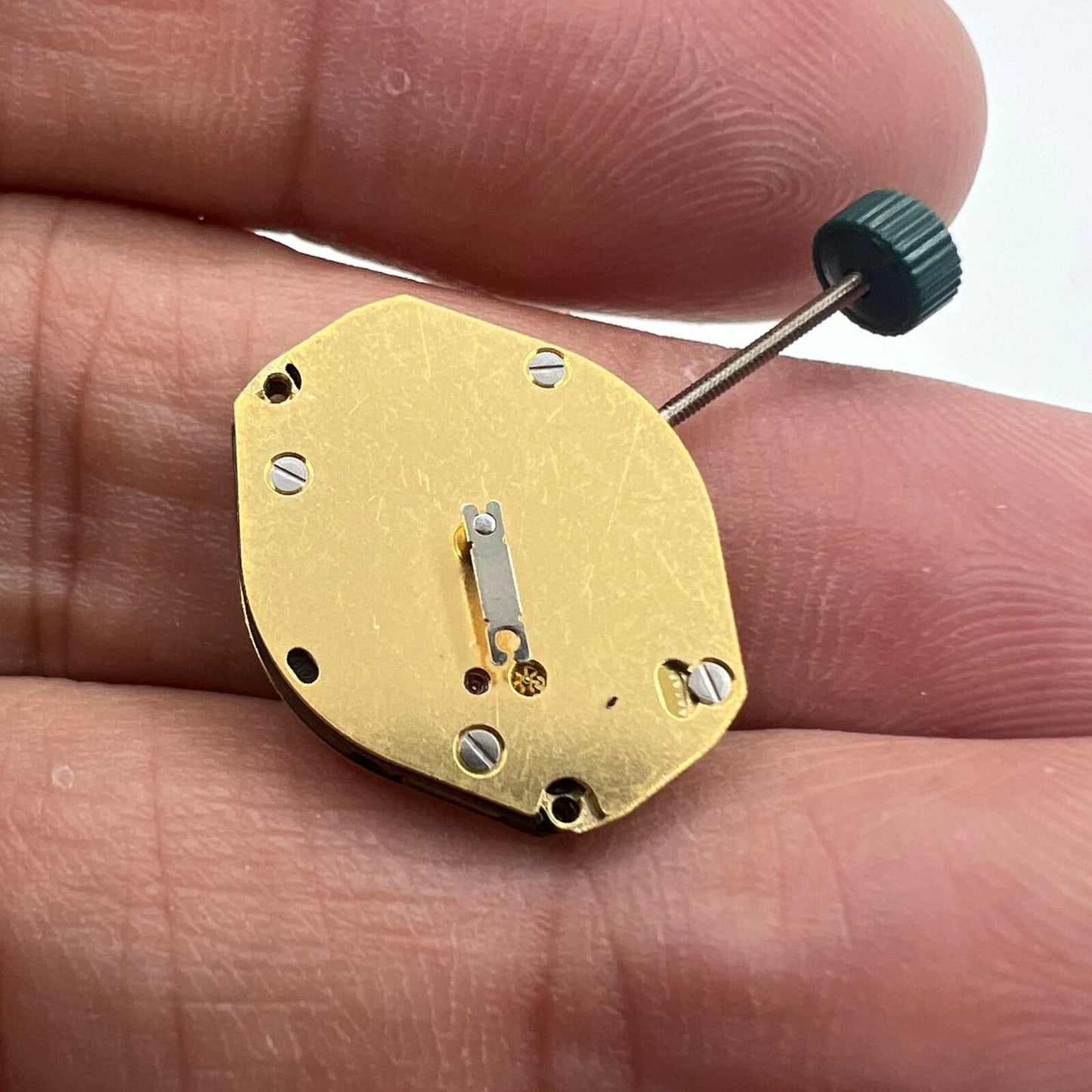 Ronda 1069 golden plated quartz watch movement, Swiss made, precision timekeeping component.