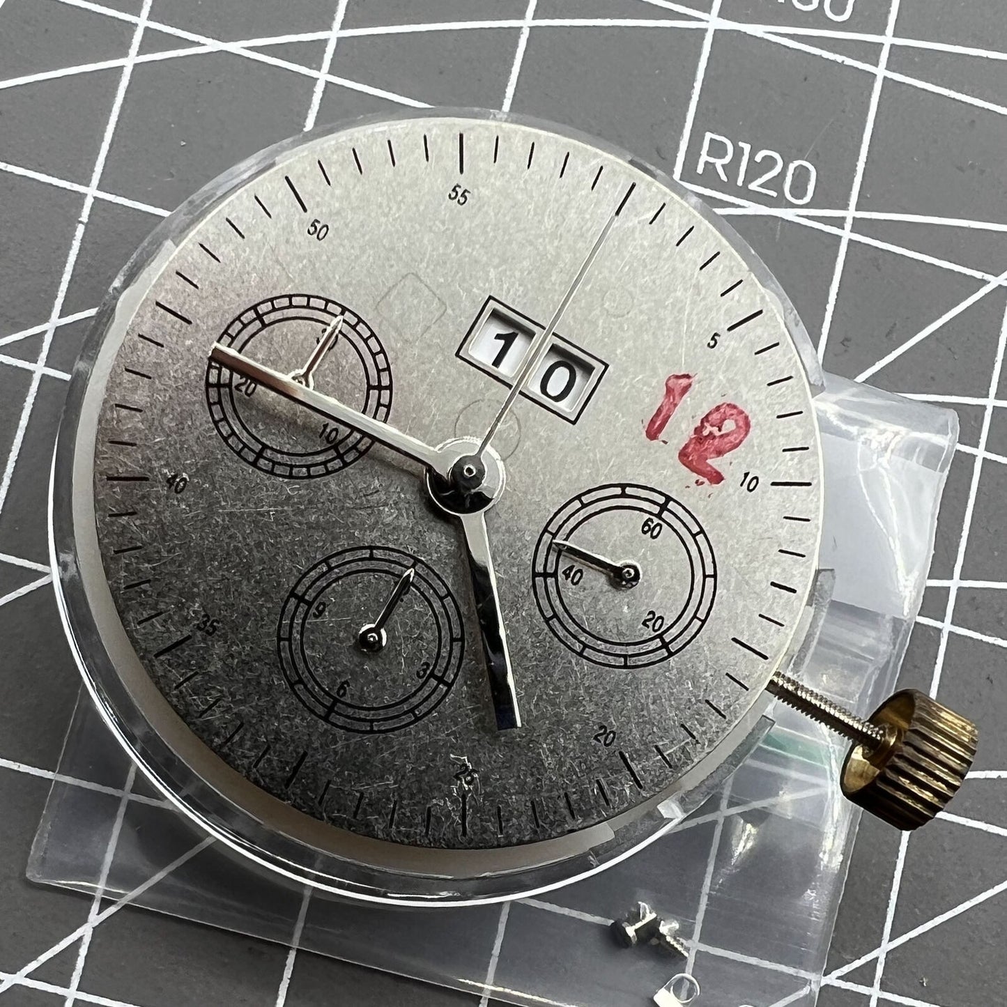 7750 mechanical watch movement showing big date at 12 and small second at 3, detailed close-up