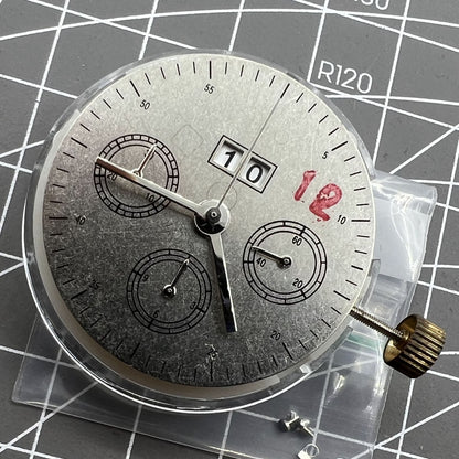 7750 mechanical watch movement showing big date at 12 and small second at 3, detailed close-up