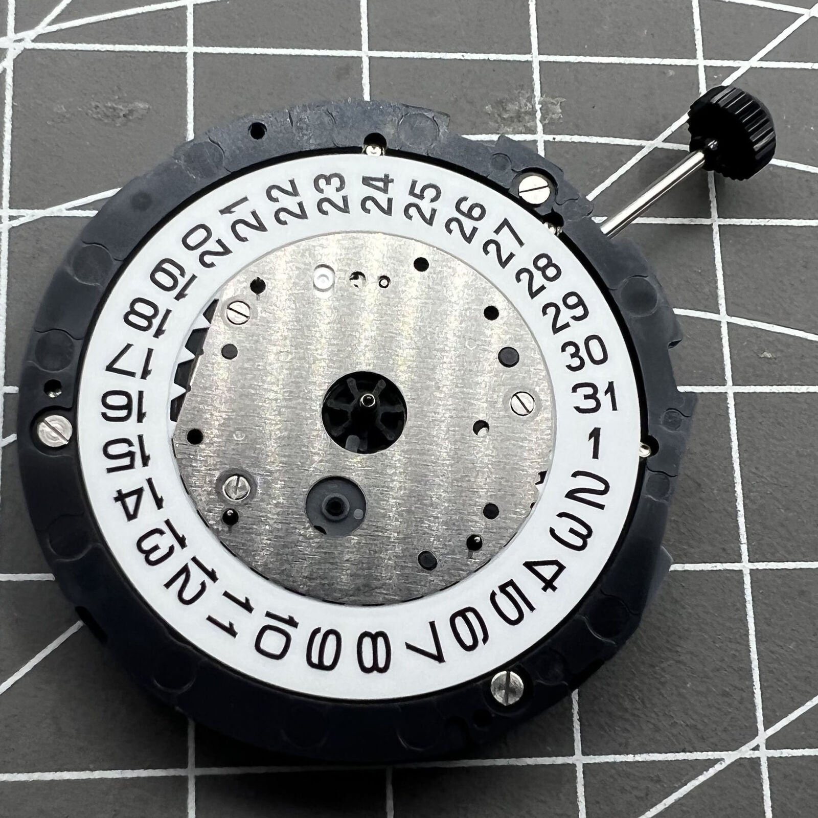 Miyota 6S10 quartz watch movement with small second hands at 6, 9, 12 o'clock positions and date at 3.