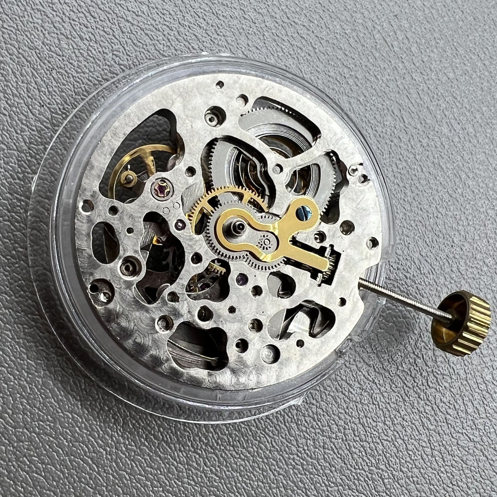 Hollow Hangzhou 2189 automatic mechanical watch movement with red rotor and three silver hands.