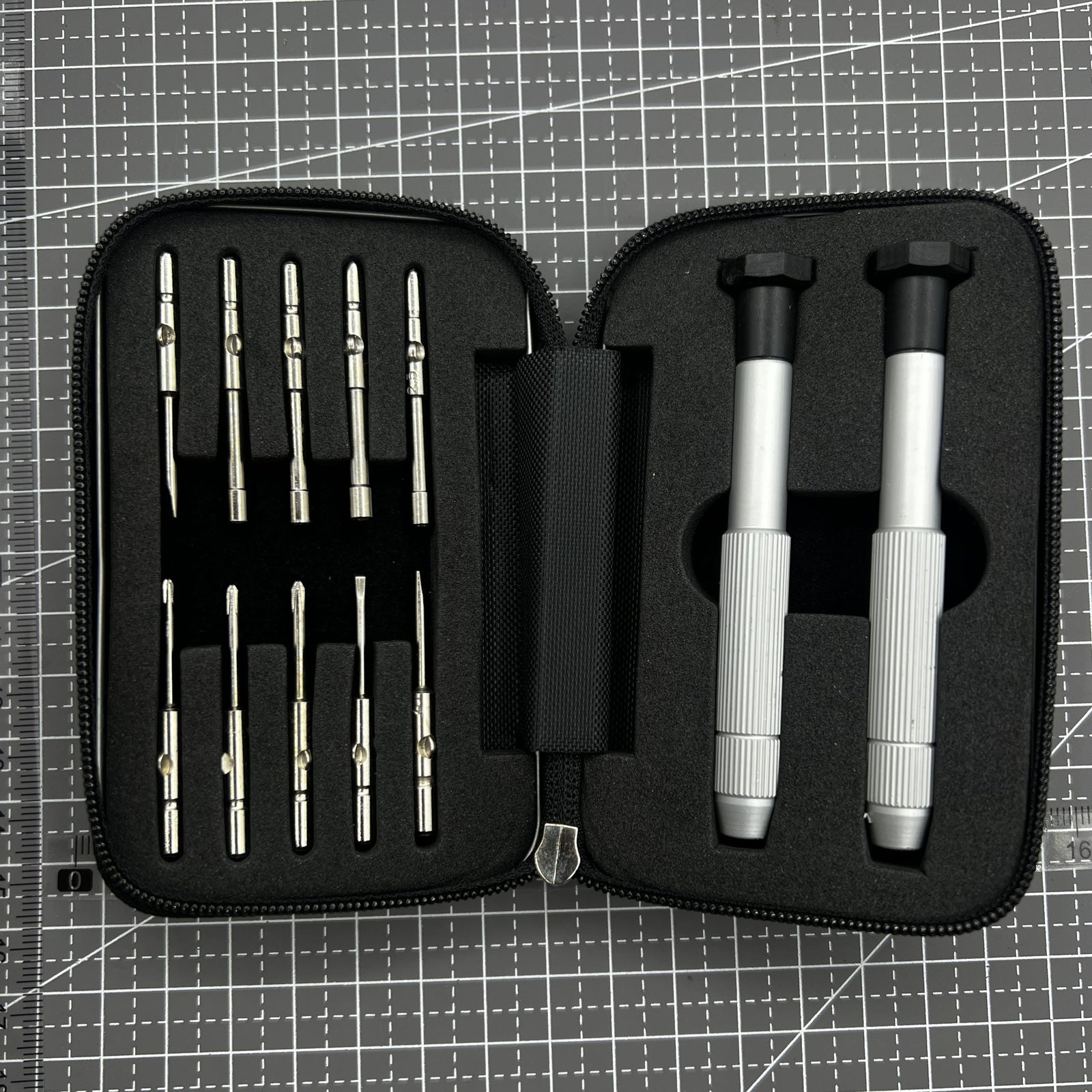 Precision screwdriver set with hex tools for watches and glasses repair, ergonomic grip.