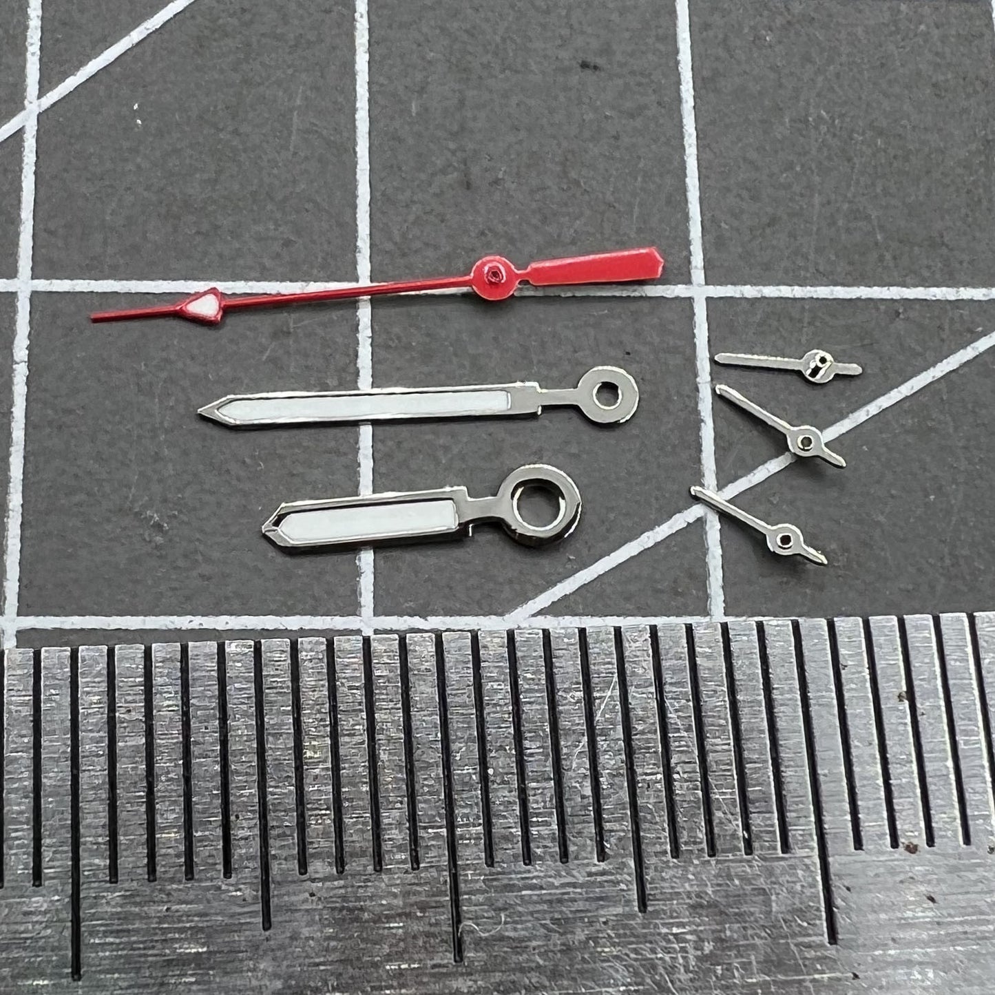 Set of 12mm watch hands with silver trim, red second hand, and green luminous for Miyota 0S10.
