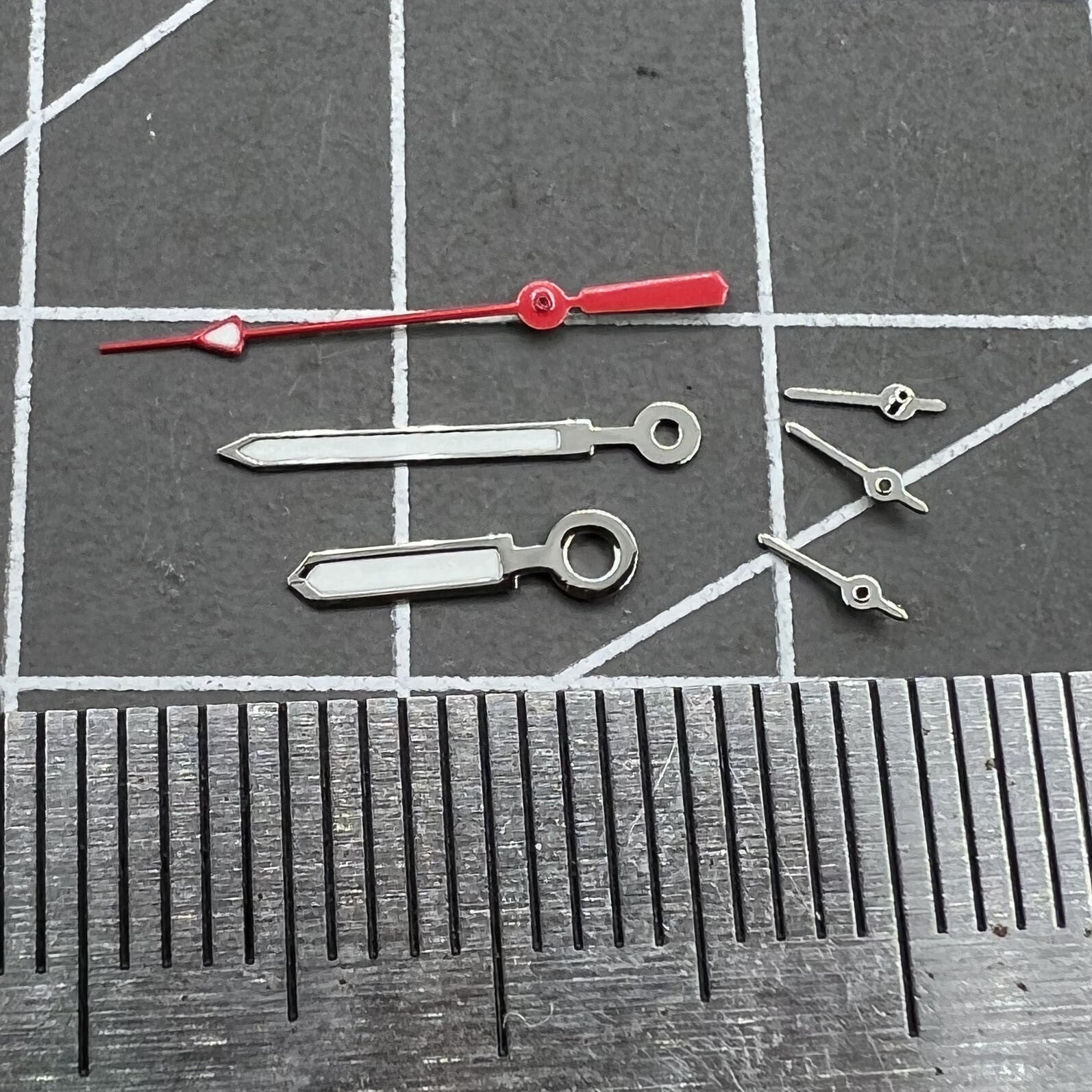 Set of 12mm watch hands with silver trim, red second hand, and green luminous for Miyota 0S10.