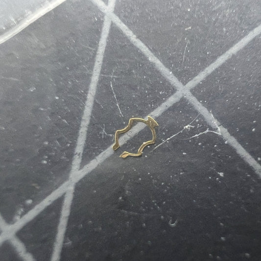 ETA watch movement plate click spring cap jewel close-up, precision component for watch repair.