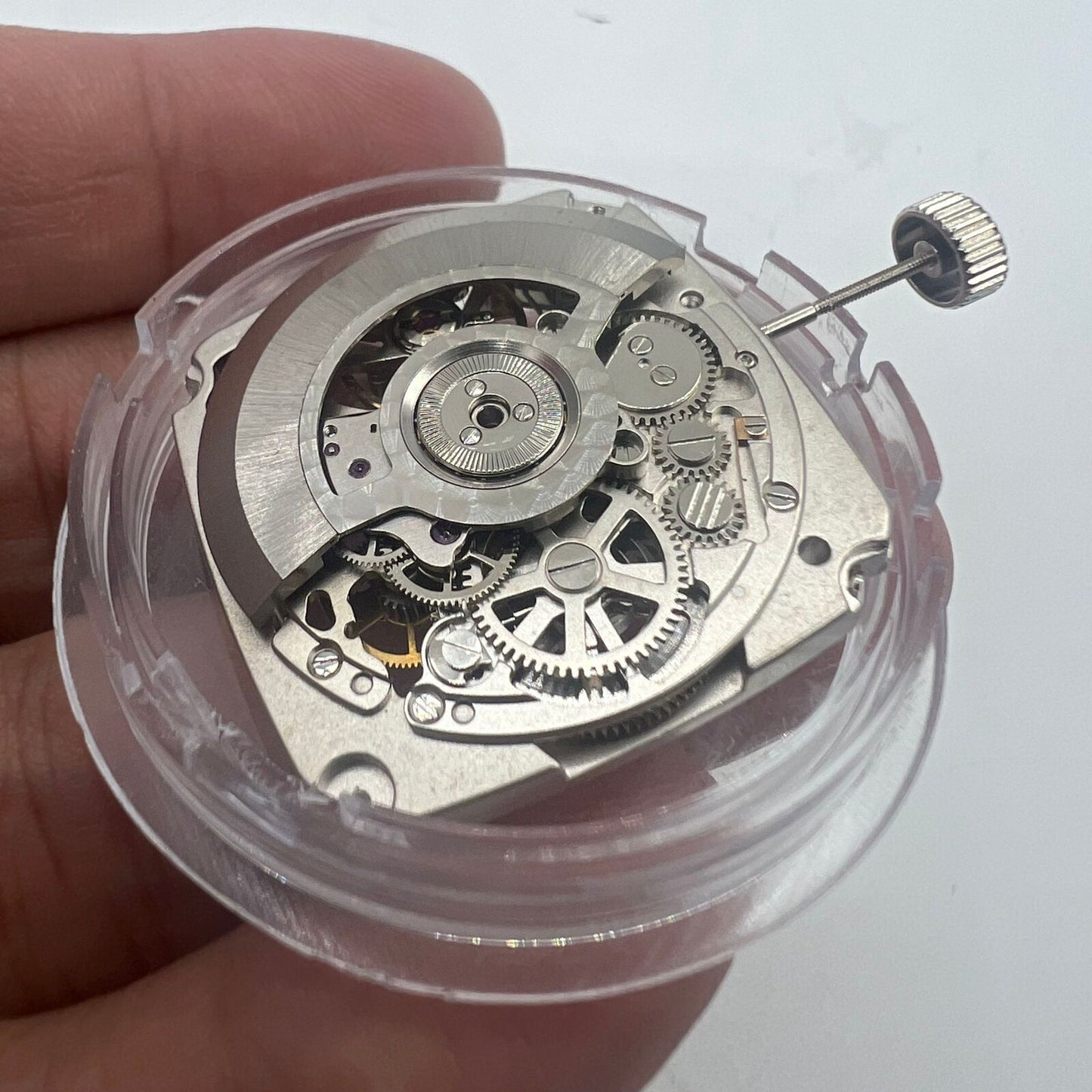 Tianjin Seagull ST25 silver automatic watch movement with hollow square design and three hands for precision timekeeping.