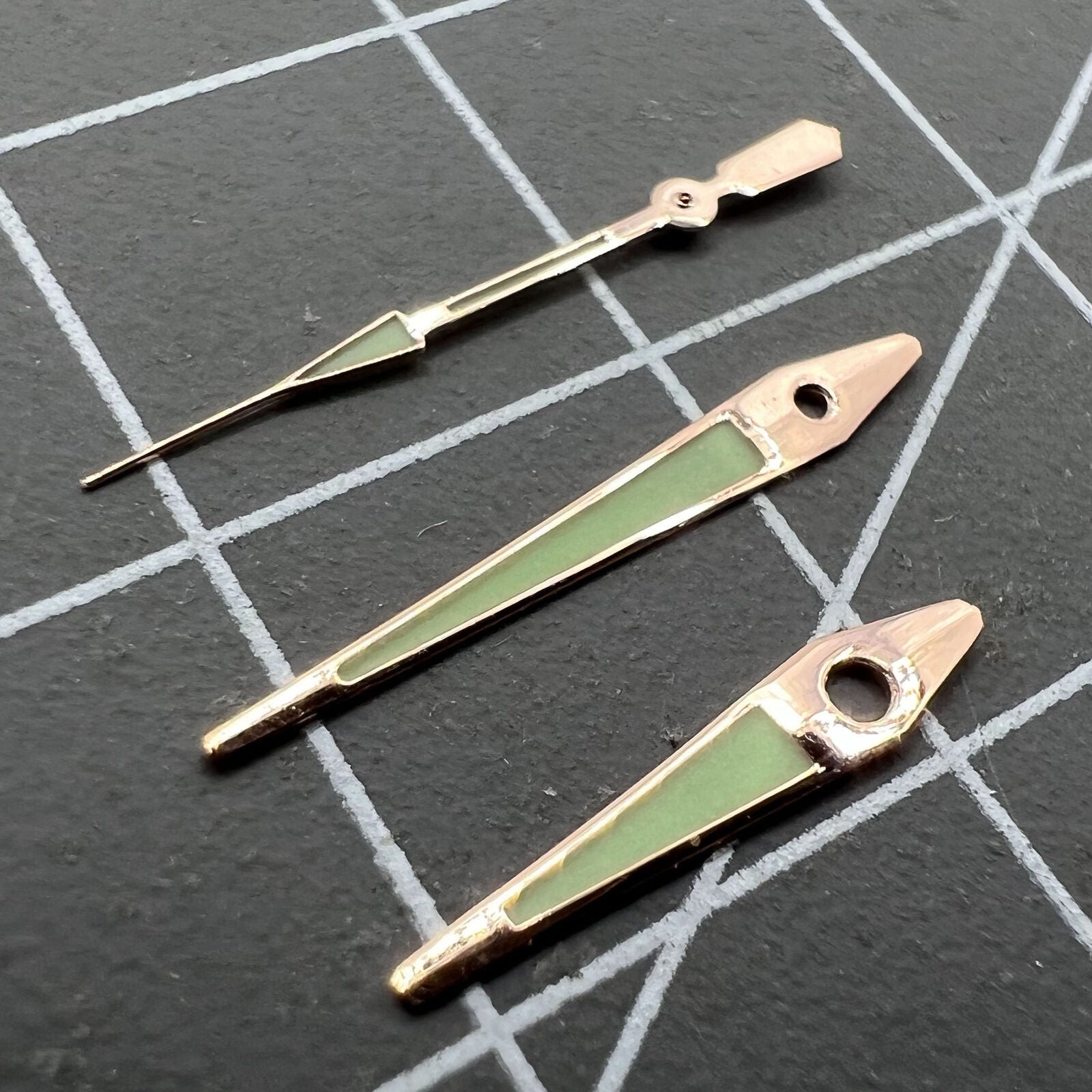 14mm rose gold arrow-shaped luminous watch hands for ISA 2331, green glow, precision accessory.