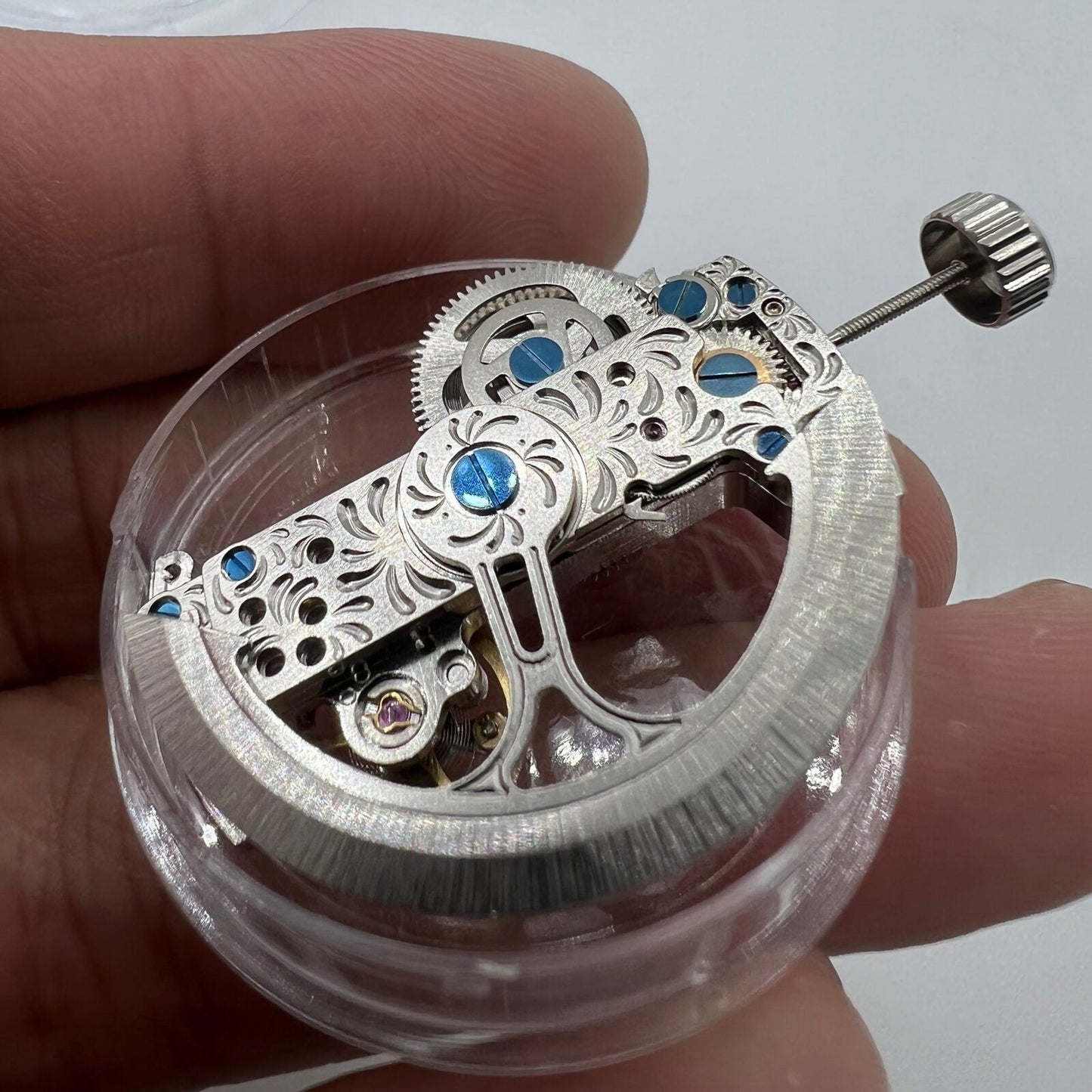 Silver long pendulum wheel watch accessory by Asian, featuring intricate automatic mechanical movement and elegant design.