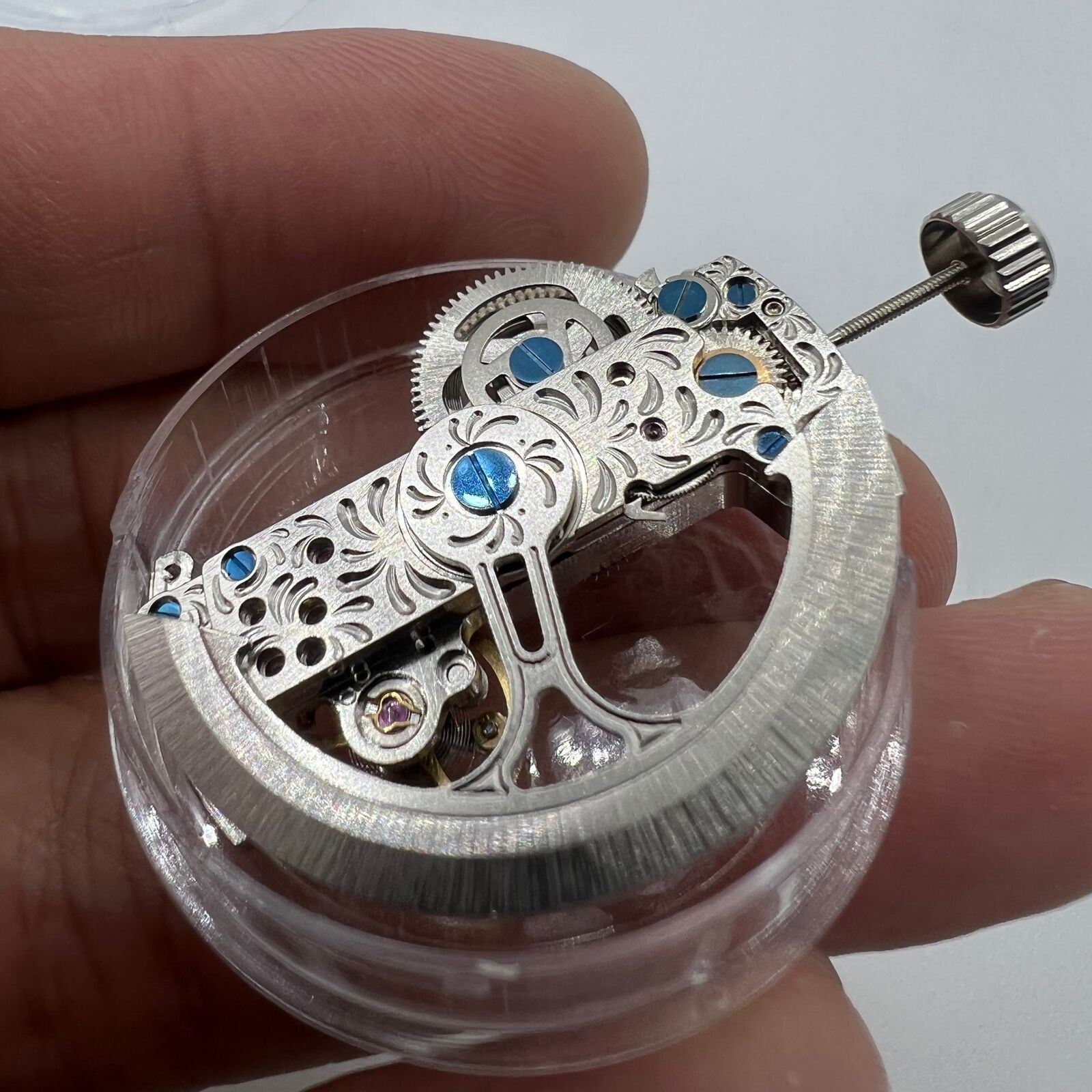 Silver long pendulum wheel watch accessory by Asian, featuring intricate automatic mechanical movement and elegant design.