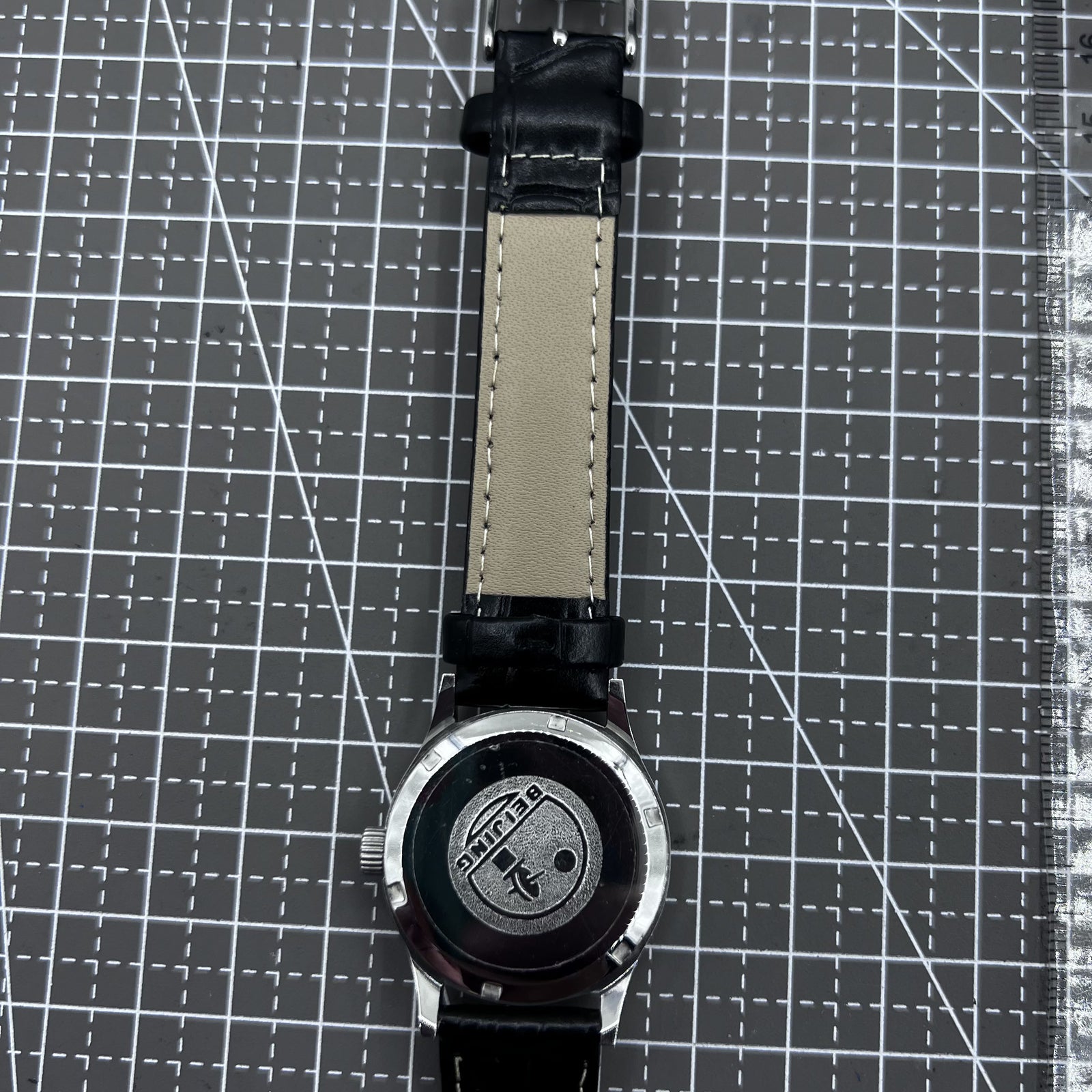 Beijing 31mm mechanical watch with black double rhomb strap, silver case, and classic three-hand design.