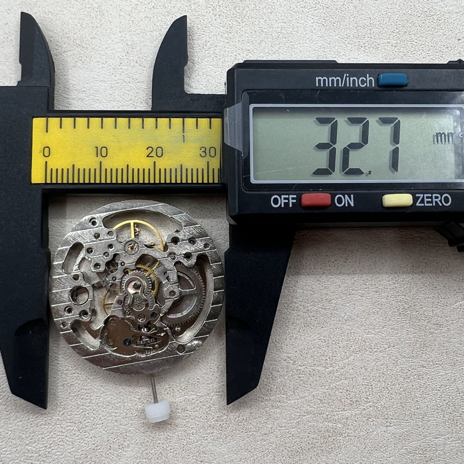 Silver mechanical hand-wound watch case with hollow design for precise timekeeping.