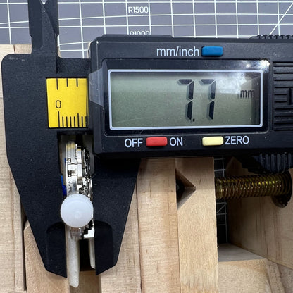 ST10 automatic mechanical watch accessory with date display and small seconds at 3, 6, 9, and 12 positions.