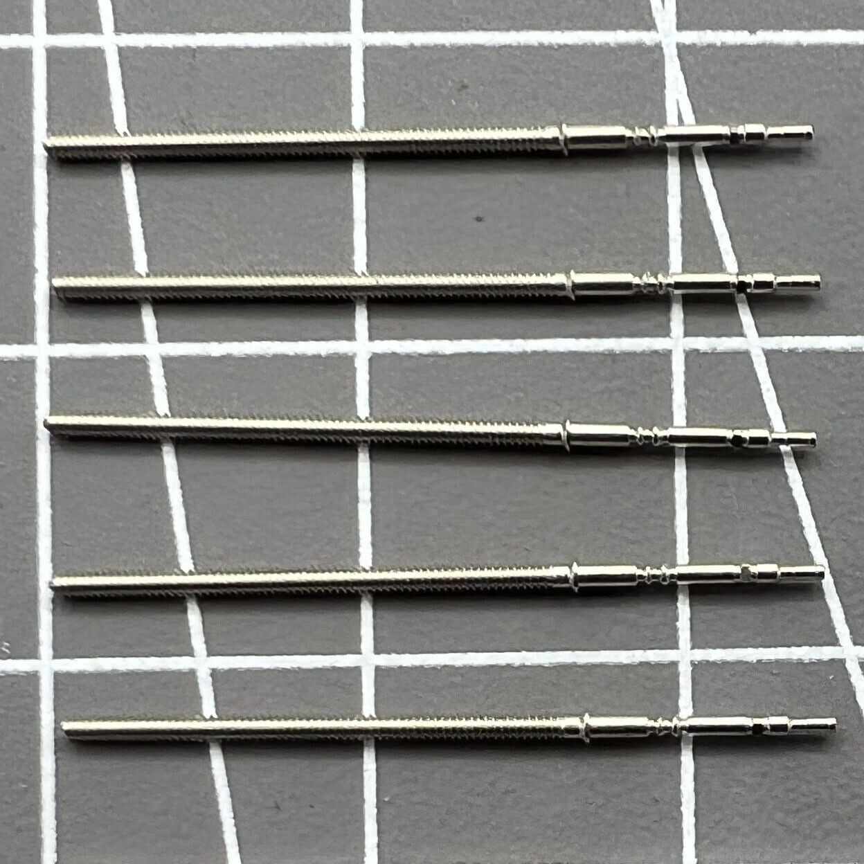 Set of 5 replacement winding stems for PE90 movement watches, durable and precise watch accessory.