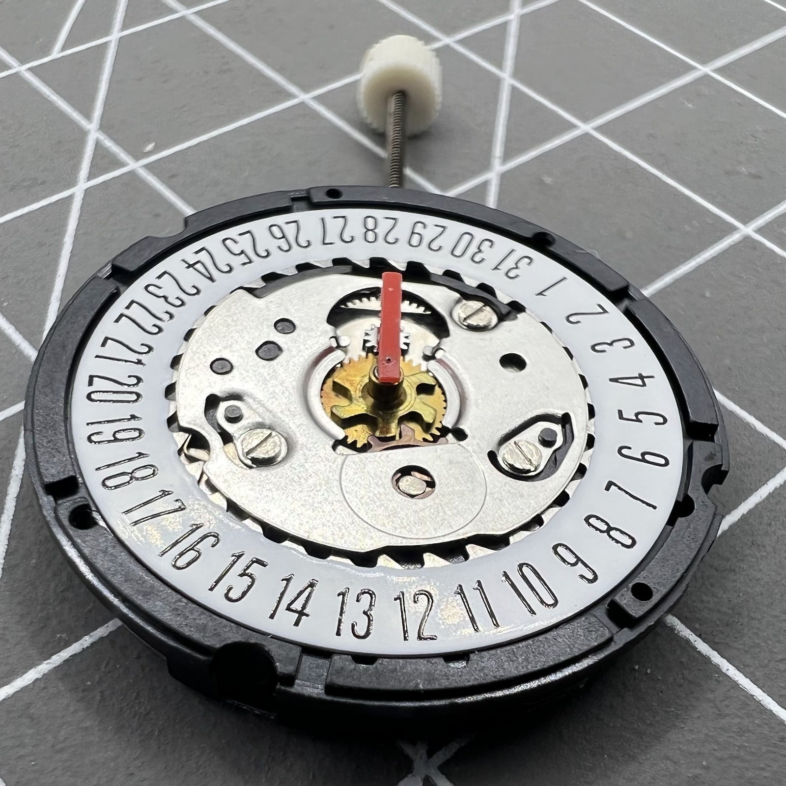 ISA 307 quartz watch movement showing date at 6, brand new old stock for accurate timekeeping.