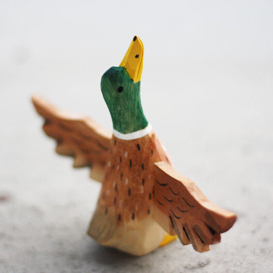 Handcrafted Flying Mallard wooden figurine, perfect decorative artwork for home or office.
