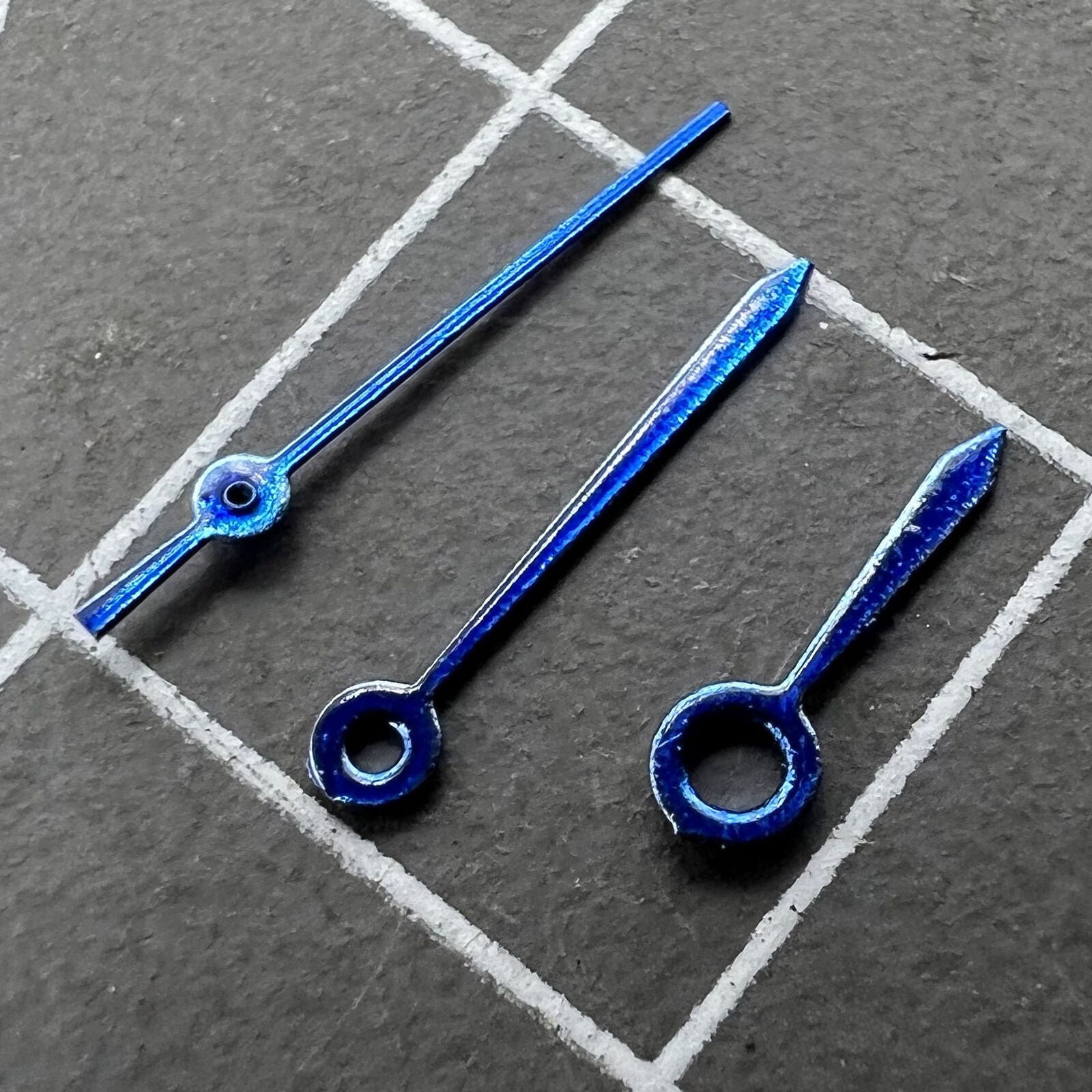 Blue 9mm arrow-shaped watch hands by Miyota for quartz movement #3, sleek design without lume.