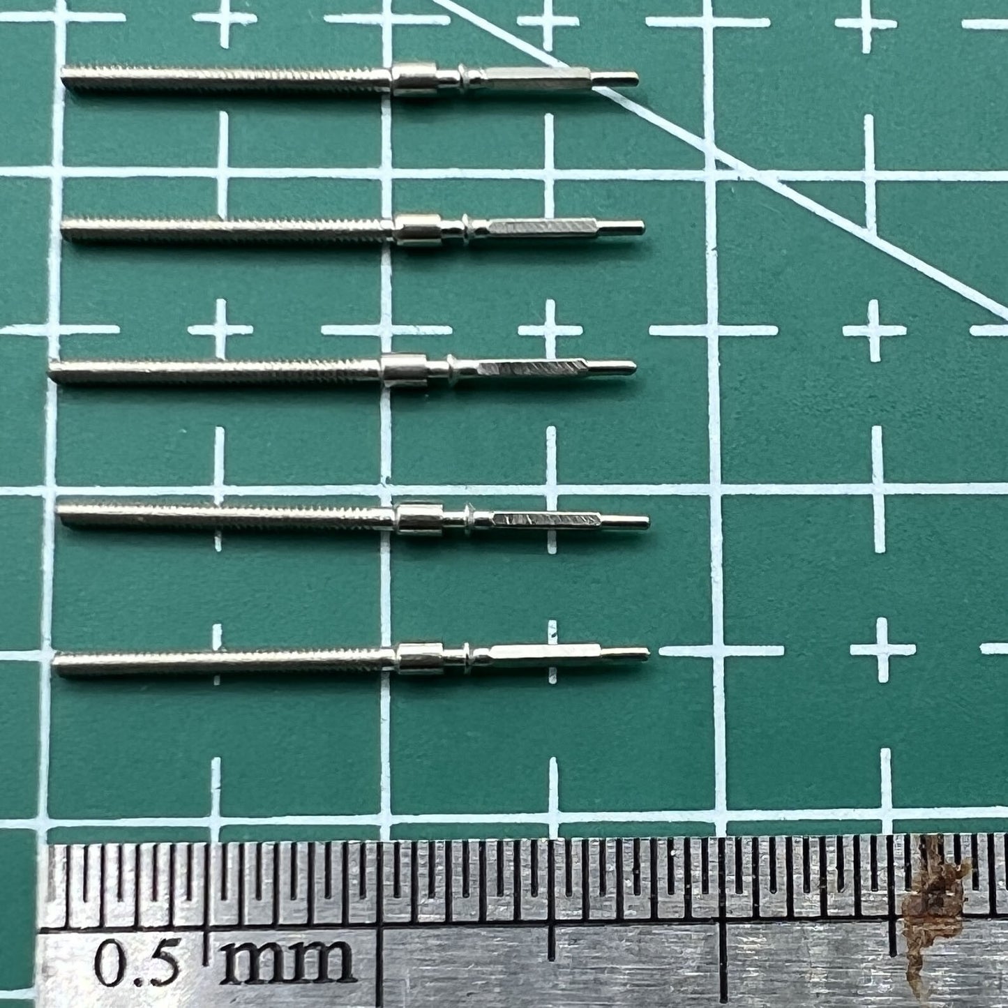 Wholesale lot of watch winding stems for 6309 movement, durable spare parts for watch repairs.
