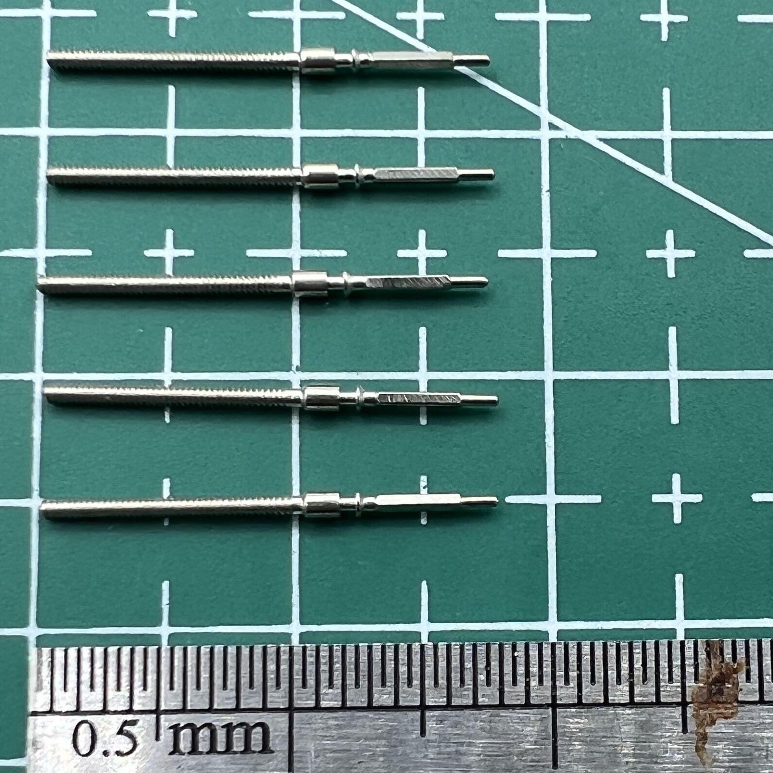 Wholesale lot of watch winding stems for 6309 movement, durable spare parts for watch repairs.