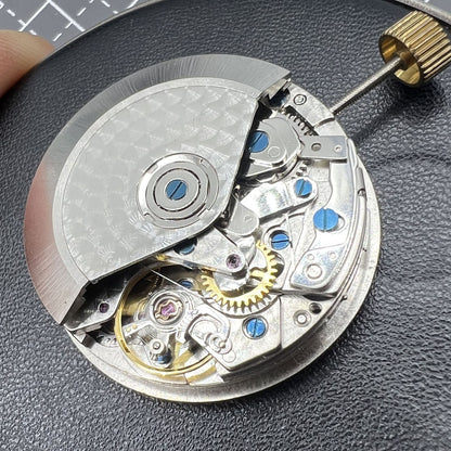 Dandong 7753 automatic watch movement with small second dial at 9 o'clock for precise timekeeping.