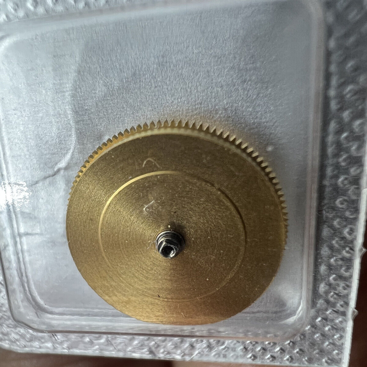 Original Omega 3303/3313 movement barrel with complete mainspring, precision watch accessory for repair and maintenance.