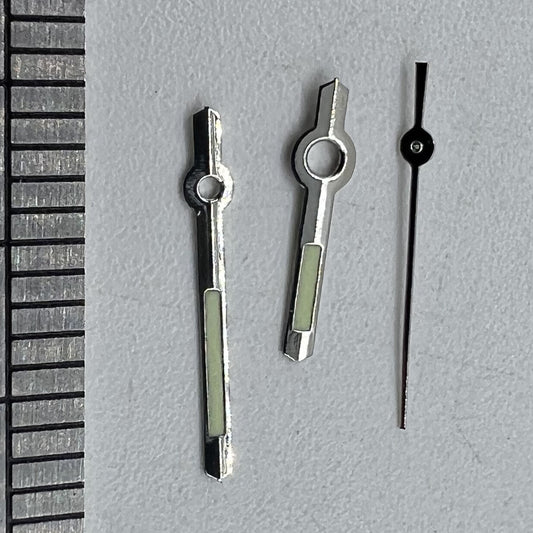 Silver luminous watch hands for Miyota 2035 quartz movement, enhancing visibility and style.
