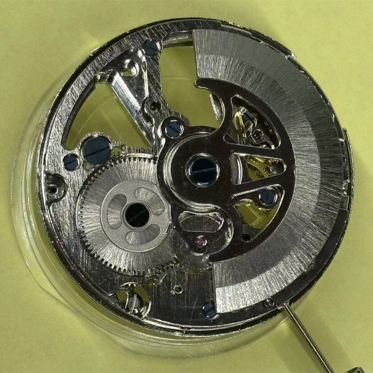 Hollow automatic mechanical watch part with moon phase at 12, precise timekeeping by China Made.