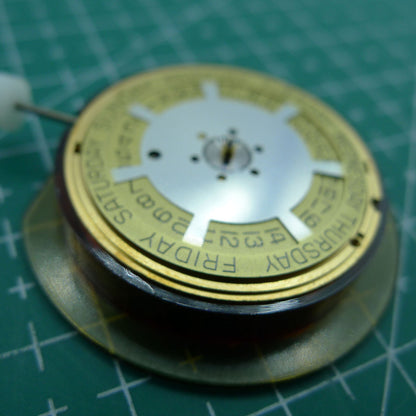Swiss Made ETA 955.132 quartz watch movement displaying double calendar with week at 12 and date at 3 features.