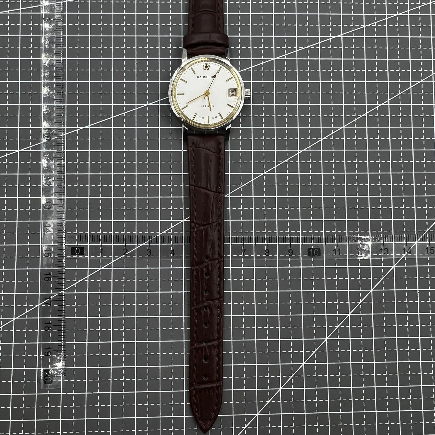 Shanghai 33mm manual mechanical watch with single calendar, 17 jewels, shock-resistant design for daily wear.