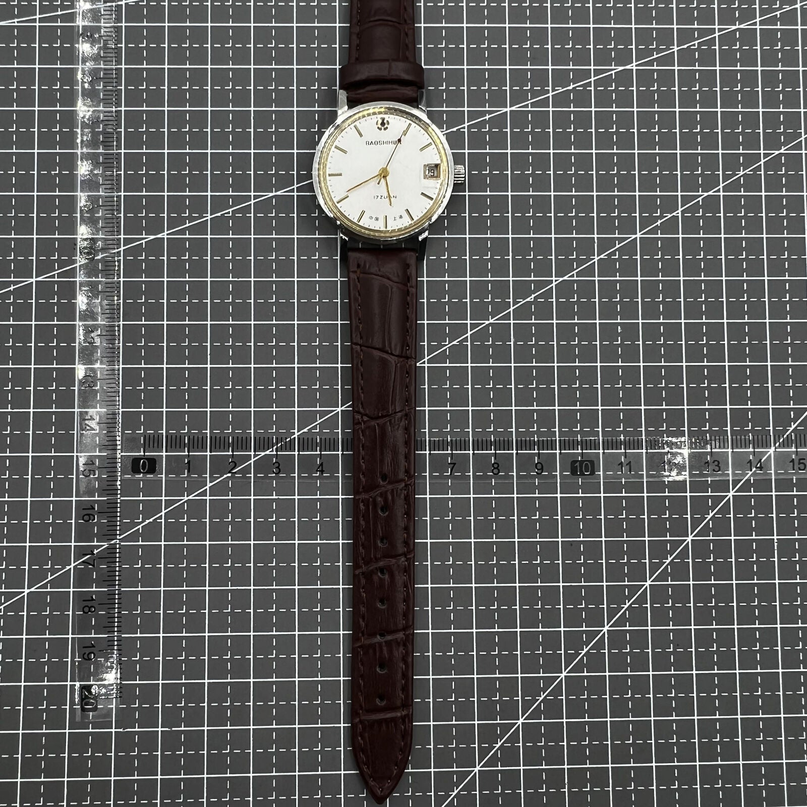 Shanghai 33mm manual mechanical watch with single calendar, 17 jewels, shock-resistant design for daily wear.