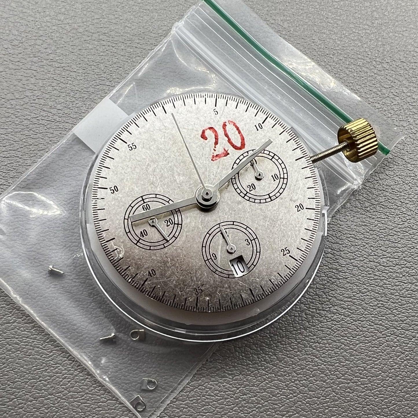 Chronograph watch accessory with ETA 7750 movement, white dial, single calendar at 6, second hand at 9.