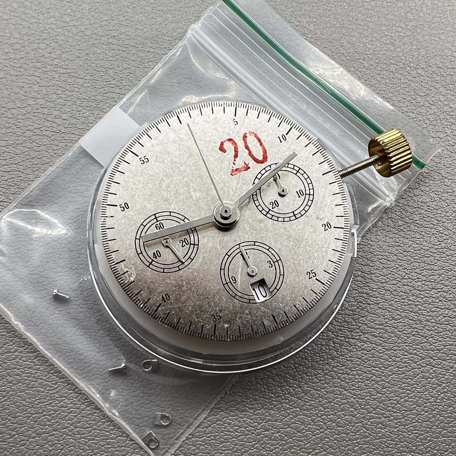 Chronograph watch accessory with ETA 7750 movement, white dial, single calendar at 6, second hand at 9.