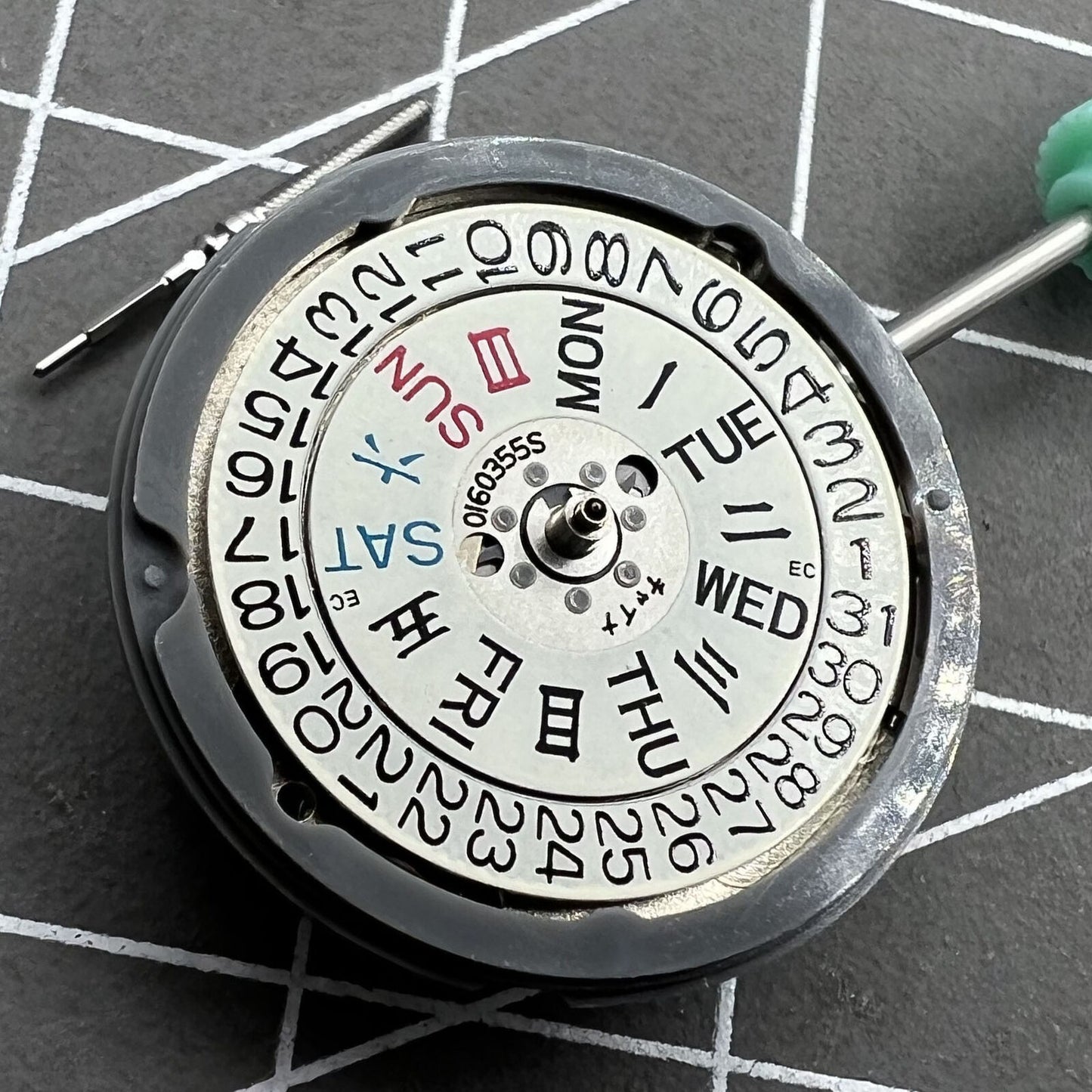 NH06A watch movement showcasing double calendar date at 3 o'clock, precision Japan-made mechanism.