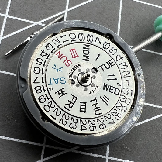 NH06A watch movement showcasing double calendar date at 3 o'clock, precision Japan-made mechanism.