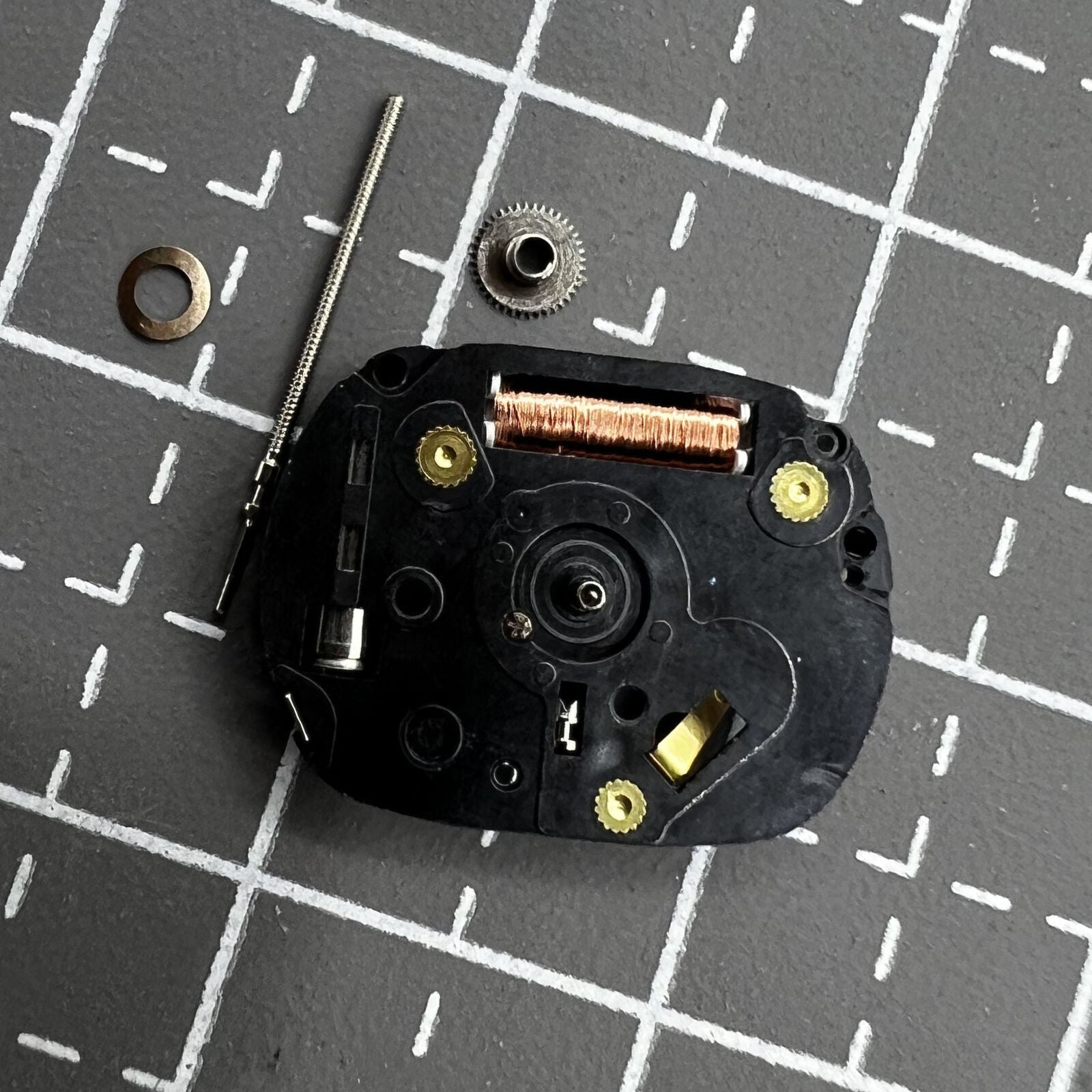 Hattori VX01 quartz watch movement with three hands, precision timekeeping for watch repair.