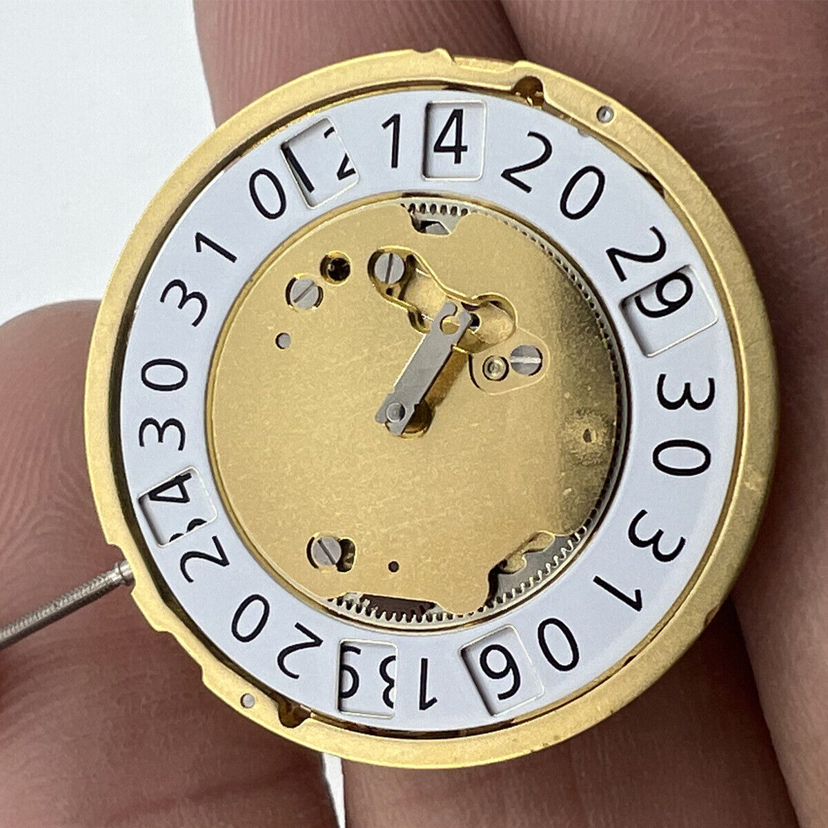 Ronda 6004B golden quartz watch movement with date at 12, Swiss made for precision timekeeping