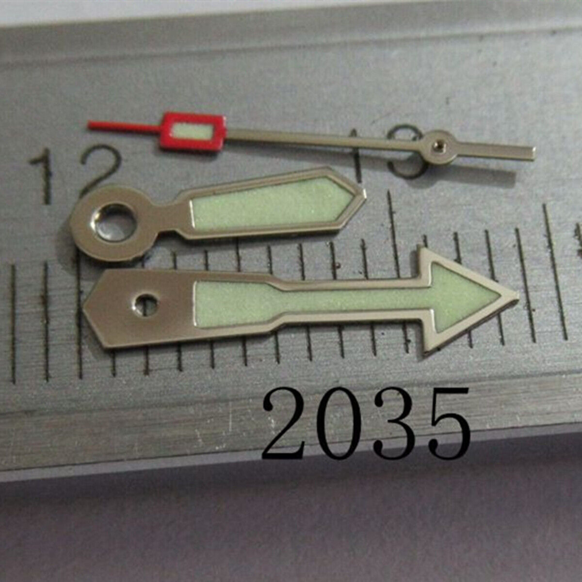 Arrow-shaped silver-trimmed green lume watch hand for Miyota 2035 movement, enhancing readability and style.